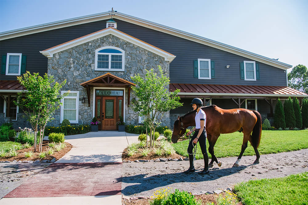 The Upper Barn contains 20 stalls, an Indoor Riding arena, multiple tack rooms, a climate-controlled viewing room, multiple bathrooms, an event room and full kitchen. 