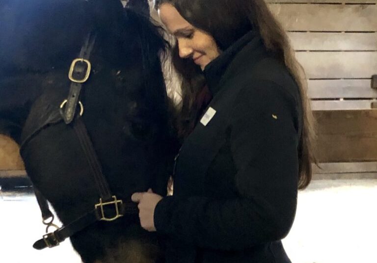 A caregiver makes tranquil connections with our equine companions. 